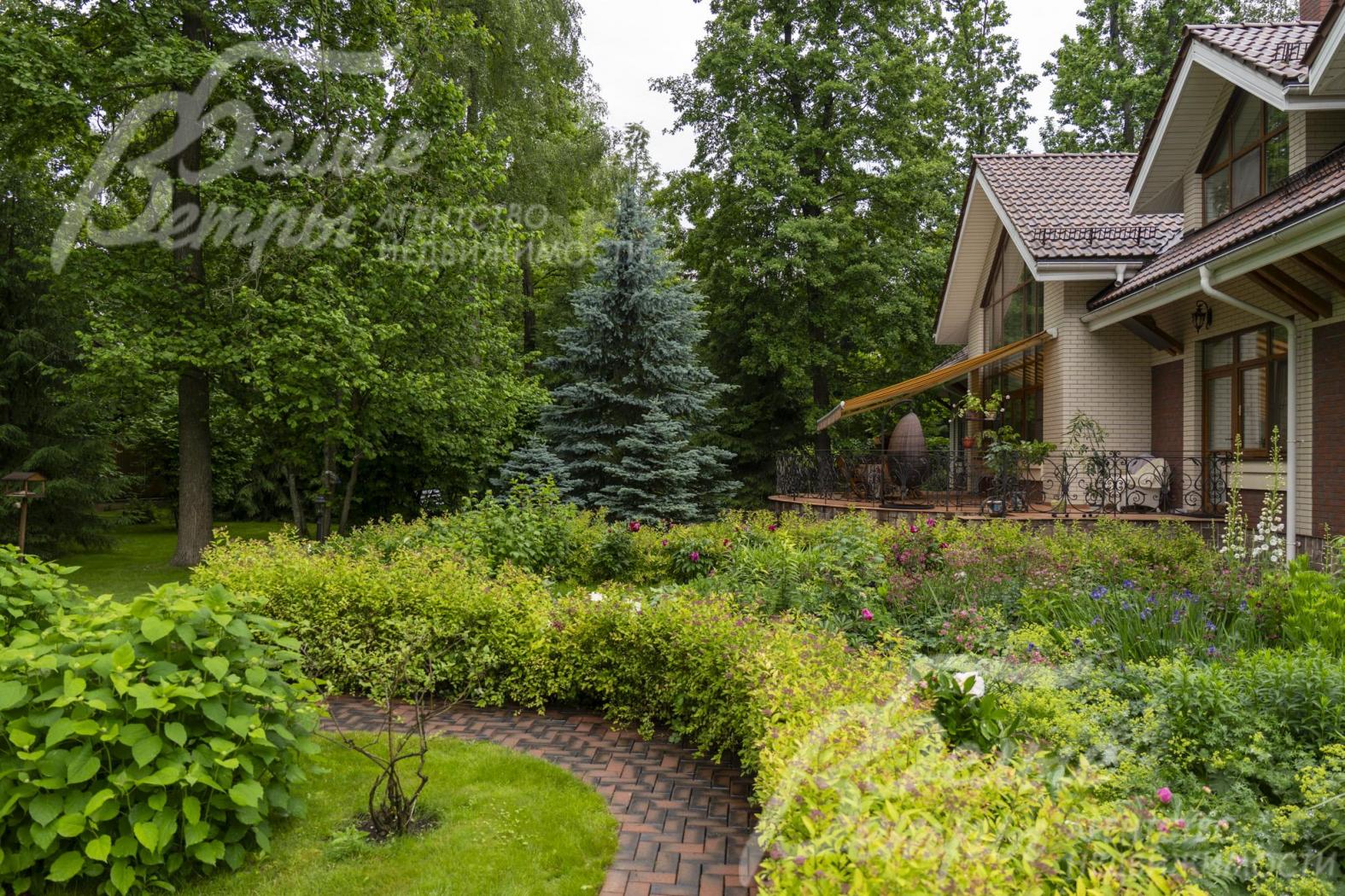 Участок украшают ухоженные декоративные кустарники и сохранённые лесные деревья