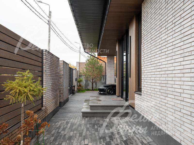 Участок огорожен по всему периметру: забор на бетонном основании и кирпичных столбах, доска - лиственница