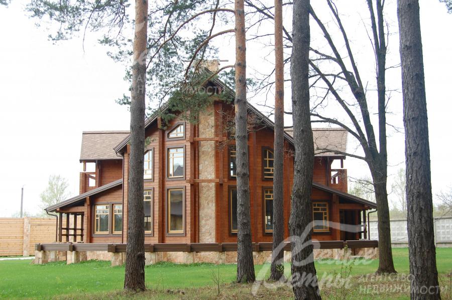 Деревянный дом на лесном участке с соснами