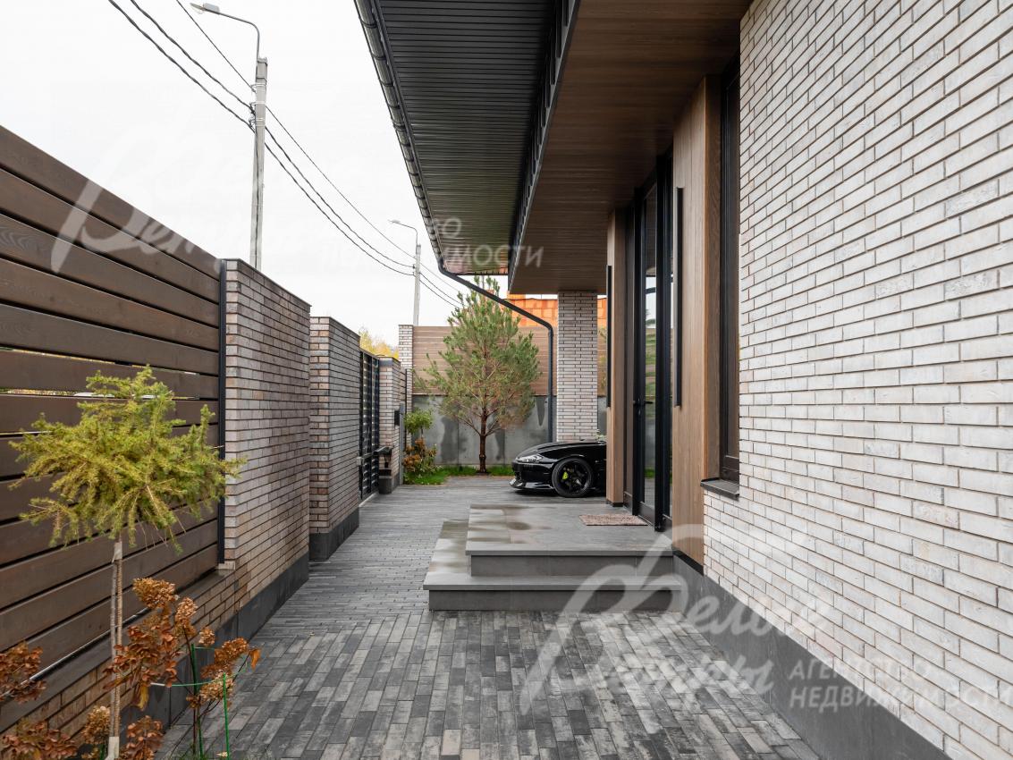 Участок огорожен по всему периметру: забор на бетонном основании и кирпичных столбах, доска - лиственница