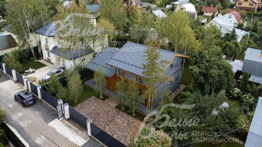 Ограждение по фасаду: металлопрофиль высотой 2,5 м на бетонном основании со столбами облицованными камнем 